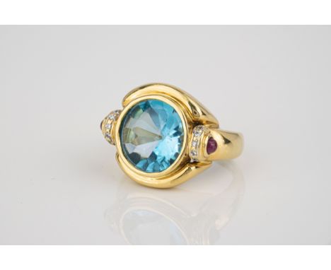 An 18ct yellow gold, topaz, ruby and diamond ring, the central mixed round cut topaz with convex top, over shoulders set with