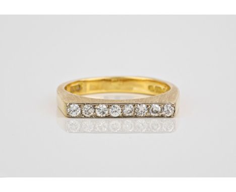 An 18ct yellow gold and diamond ring, hallmarked London 1977, the flat topped, burnished shank set with eight brilliant cut d