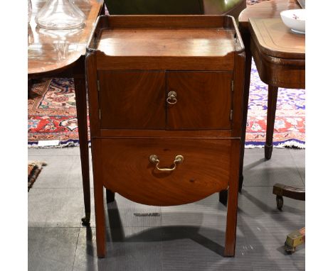 A George III mahogany tray top night table, with pierced handles to the top, over a pair of cupboard doors and converted draw