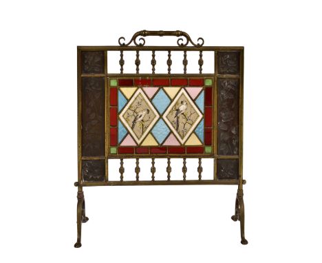 A Victorian brass and stained glass fire screen, the pierced rectangular screen decorated with climbing roses, fuchsia and tu