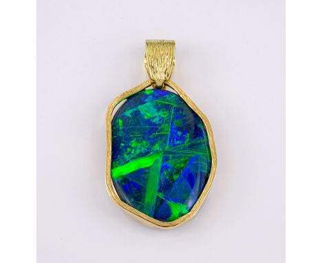 A fine 18ct gold and black opal pendant, the oval 29 x 21mm. opal of fine colour and iridescence, approx. 9ct, within a shape