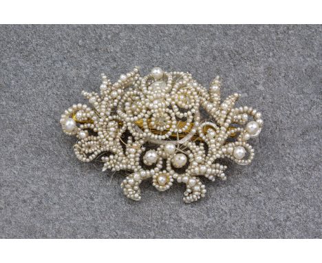 A Victorian seed pearl, mother of pearl and gold brooch, With seed pearls arranged in an openwork foliate design with 6 large