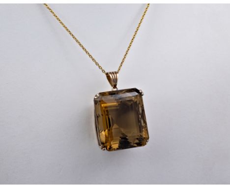 A 1970s 20ct smoky quartz pendant, the smoky quartz is emerald cut, light golden brown in colour and measuring approximately 