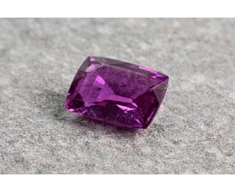 A natural, unheated loose purple sapphire, accompanied with a certificate from the Gem and Pearl Laboratory and totalling app