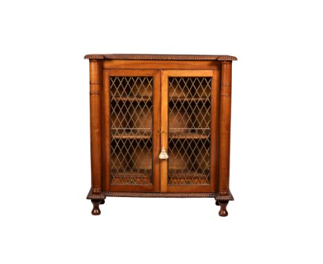 A William IV satin walnut inverted breakfront bookcase, the reel moulded top with outset corners supported on turned pillars,