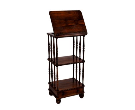 A William IV rosewood three tier whatnot with reading stand, the hinged reading stand to the top with easel back and hinged b