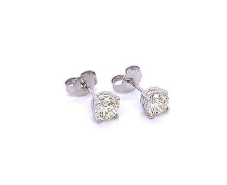 A pair of Classic 4 Claw Solitaire Diamond Stud Earrings crafted in 14K White Gold, set with 2 round brilliant cut diamonds t