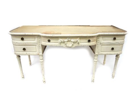 A carved white painted mahogany bedroom suite in Louis XVI style, early 20th century, comprising: a dressing table, with five