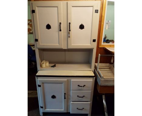 A 1950s painted larder cupboard fitted with enamel slide and three short drawers