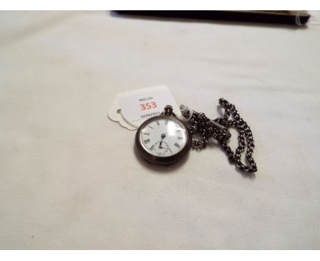 A ladies white metal pocket watch with Roman numerals and secondary dial and an Albert chain