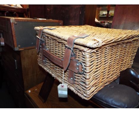 A wicker picnic hamper and fitted contents