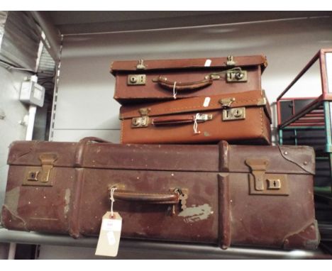 Three leather and leather effect vintage suitcases
