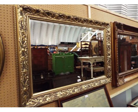 A gilt framed bevelled glass mirror with art nouveau floral decoration 