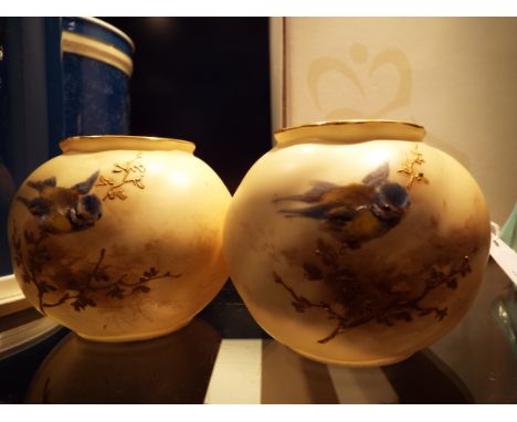 A pair of Royal Worcester blush ivory vases of ovoid form hand painted with blue tits on gilt branches