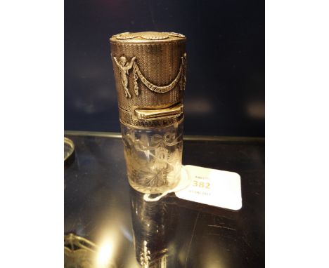 A French silver perfume bottle, the silvered top having engine turned decoration with applied cherubs and garlands, the glass