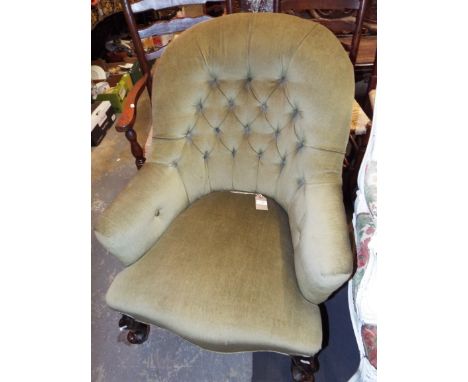 A green button back armchair having serpentine seat 