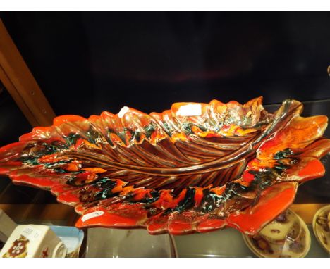 A mid 20thC pottery leaf dish in the style of Poole indistinctly signed to base