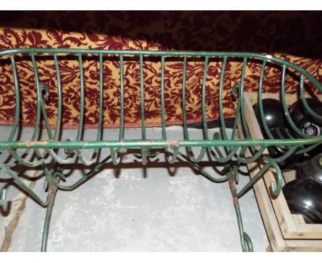 An ornate green painted iron plant trough