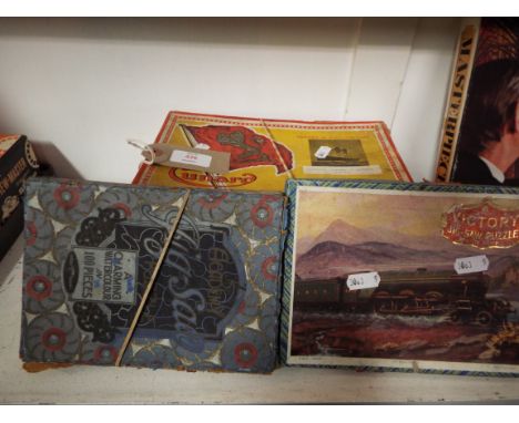 Two vintage wooden jigsaw puzzles of Cunard Ocean liners, made by the Chad Valley Co. together with two wooden jigsaw puzzles
