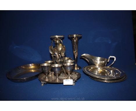 A quantity of plated items including six egg cups and spoons on a stand, a pair of trumpet vases, three small salvers etc.