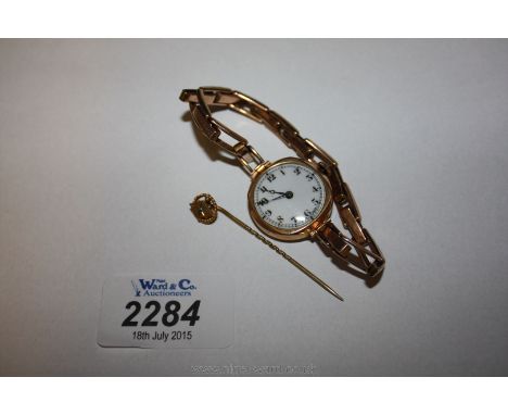 A Ladies 9ct Gold Wristwatch and a 9ct Gold Stick Pin with green stone