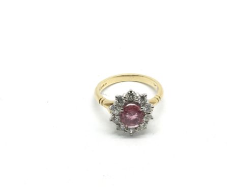 An 18ct gold oval ruby and diamond cluster ring, ruby approx 1.50ct, diamonds approx 1ct, approx total weight 4.5g and approx