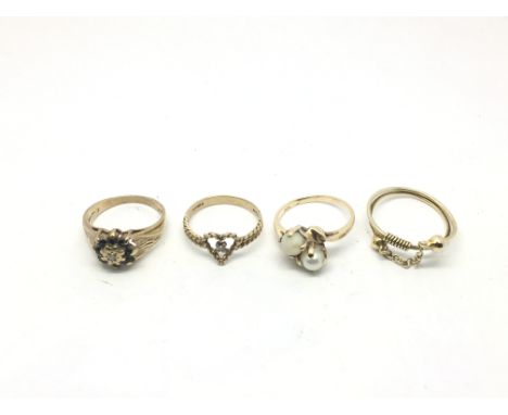 A 10ct gold pearl crossover ring, 9ct gold diamond and sapphire cluster ring plus two other 9ct gold rings (4). Approx total 