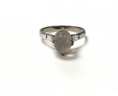 An 18ct white gold ring set with an opal. The approximate ring size is between L and M.