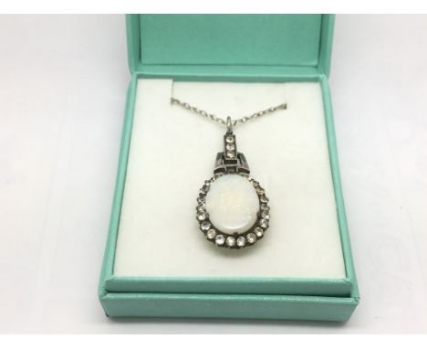 A gold and silver opal pendant on chain.