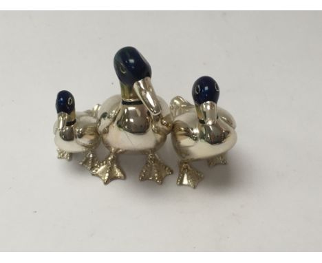 Three miniature ducks in silver and enamel.