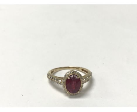 A ruby and diamond cluster ring, measuring approximately between M and N.