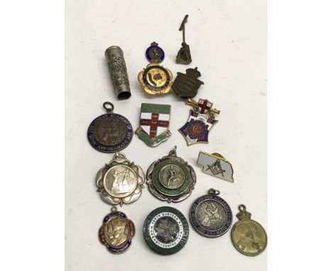 A collection of vintage enamel badges and sports medal including one silver.