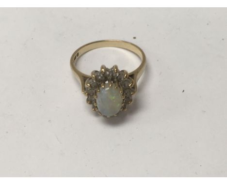 A 9 ct opal ring surrounded by Diamonds.