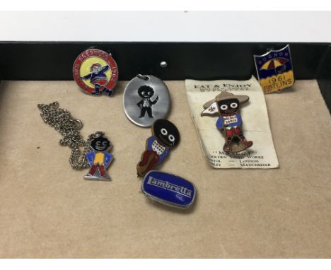 A group of golden shred marmalade and Butlin enamel pins and pendants.