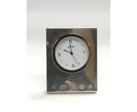 A small silver cased travelling clock, Sheffield hallmarks.