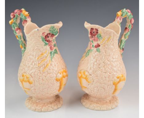 Clarice Cliff pair of pink Celtic Harvest pedestal jugs, height 20cm