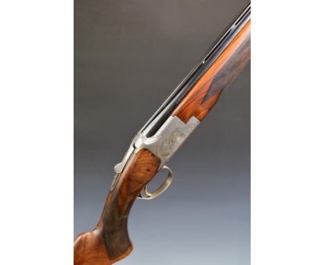 Browning B2G 12 bore over and under ejector shotgun with with scenes of birds and scrolling and foliate engraving to the lock