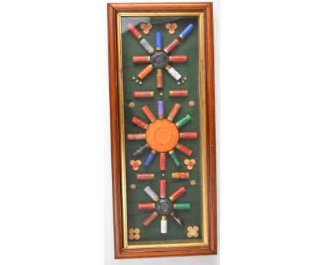 Shotgun cartridge and clay display board or case, framed and glazed, 38 x 82cm.&nbsp;We are not able to post this lot.