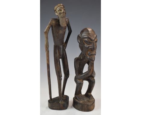 Two African carved&nbsp;tribal figures including an elder with stick, tallest 32cm