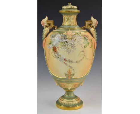 Royal Worcester blush ivory pedestal vase with twin mask handles, relief moulded detail and decorated with flowers, shape no 