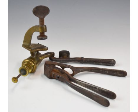 Two shotgun cartridge re-loading tools comprising a Kynoch brass 12 bore rollover tool and a cartridge de-capper or puller.&n
