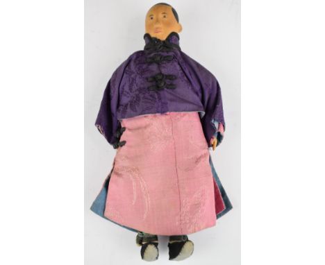 Chinese 'Door of Hope' doll wearing a red robe, purple silk jacket and cream under trousers, height 28.5cm