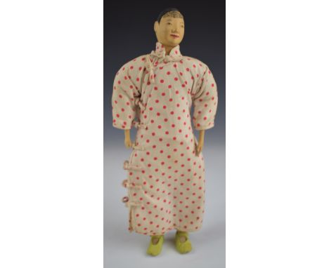 Chinese 'Door of Hope' doll wearing a red polka dot dress and under trousers, height 26.5cm