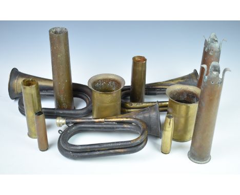 Four pieces of trench art fashioned from brass shell cases, two dated 1917, together with four additional brass cases and thr