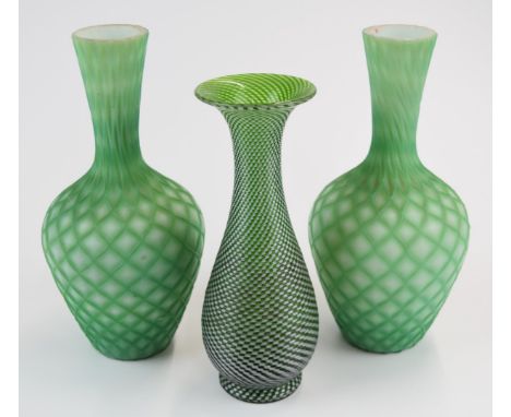 Three Stourbridge glass vases comprising a pair of quilted air trap satin bottles vases (21.5cm tall) and a Richardsons vase 