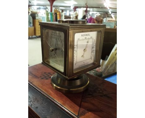 Brass bodied Angelus weather station / barometer, cube shape on rotating base. Compass to top, the four side sections showing