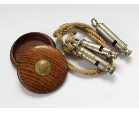 G.W.R. ETC. An oak box with Great Western Railway brass button top & three various whistles, two Metropolitan & one Acme City
