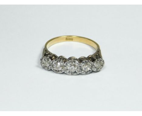 DIAMOND RING. An 18ct. gold, five stone illusion set diamond ring. Size O.  Please note that all items in this auction are pr