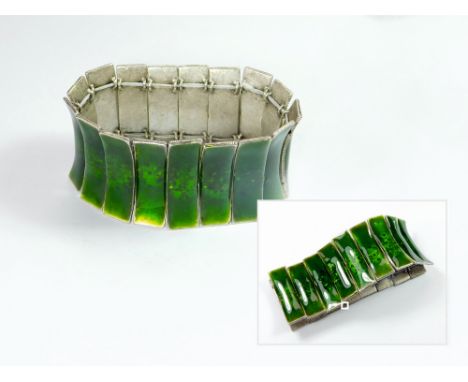 ENAMEL BRACELET. A green enamelled, vintage bracelet of curved shape. (Elasticated)  Please note that all items in this aucti