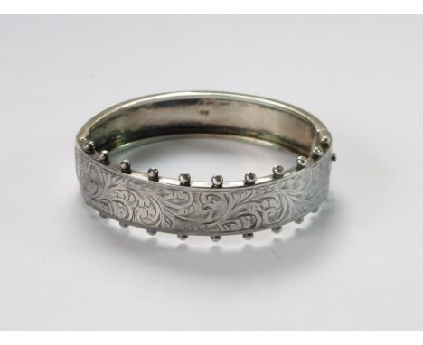 SILVER BANGLE. A hinged silver bangle in Victorian beaded style. Chester 1953.  Please note that all items in this auction ar